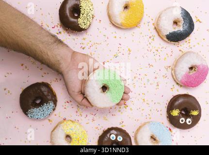 Concetto di persone, cibo, cibo spazzatura e cibo - primo piano di una donna che tiene la ciambella smaltata Foto Stock