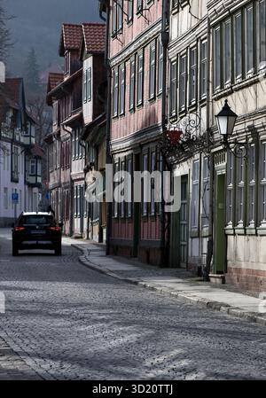 Case a graticcio nel centro storico con un'auto in una strada stretta, Wernigerode, Harz, Sassonia-Anhalt, Germania, Europa Foto Stock