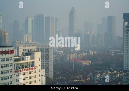 Paesaggio urbano di Foggy con grattacieli moderni e denso sviluppo urbano sullo sfondo. Wuhan, Cina Foto Stock