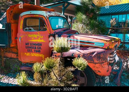 Un vecchio camion malmenato, che pubblicizza il Mt Lemmon Lumber Co. 1940, parcheggiato di fronte al Mt. Le cabine del Lemmon Hotel ricordano a tutti che il legno indu Foto Stock