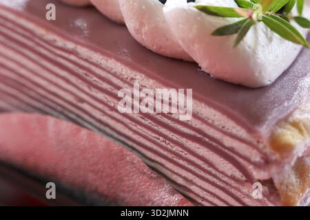 Deliziosa torta viola a strati, dolce dolce dolce da dessert adornato con delicata panna. Questa allettante delizia offre piacevoli coccole, perfette per qualsiasi cesto Foto Stock