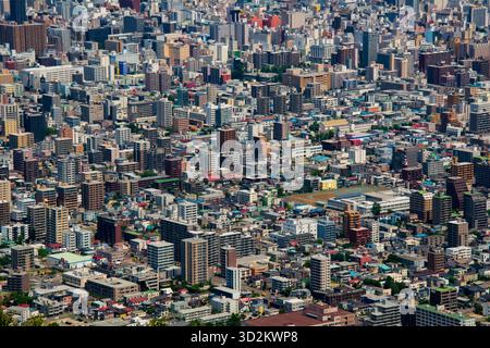 Un'area urbana densamente popolata catturata da una prospettiva aerea ad alto angolo in una giornata intensa. Gli edifici colorati, un mix di residenziale e commerciale Foto Stock