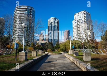 Un passaggio pedonale attraverso l'Andy Livingstone Park a Vancouver, British Columbia. Tra i condomini più recenti ci sono la Sun Tower e il Vancouver Lookout. Foto Stock
