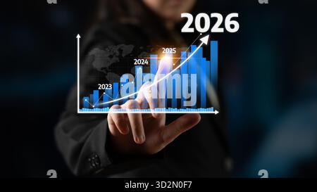 Un professionista aziendale dimostra la crescita finanziaria attraverso la visualizzazione interattiva dei dati, mostrando le tendenze previste per il periodo dal 2023 al 2026 in un moderno Foto Stock