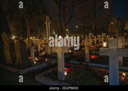 Cimitero con croci e candele di notte, sfondo del giorno di Ognissanti in Polonia Foto Stock