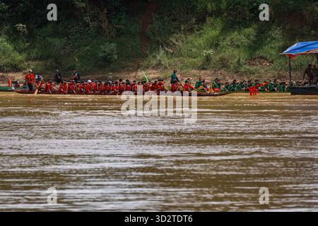 Corse tradizionali in barca, Attapeu, Laos, festival Boun Suang Heua, variopinti pagaiatori, cultura Mekong, energia fluviale e lavoro di squadra Foto Stock