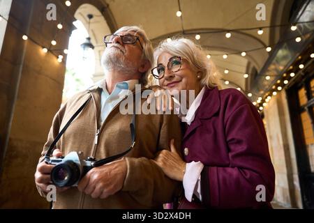 Coppia senior in viaggio per esplorare la città con la fotocamera Foto Stock
