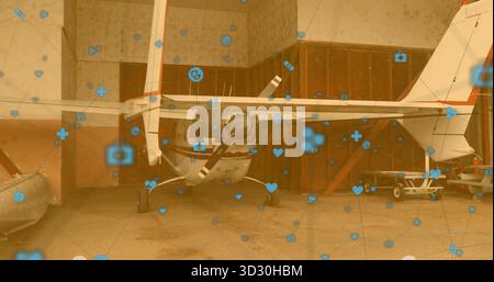 Mostra l'aereo ad elica all'interno delle porte dell'hangar, il gommone, il carrello e le icone semitrasparenti sovrapposte Foto Stock