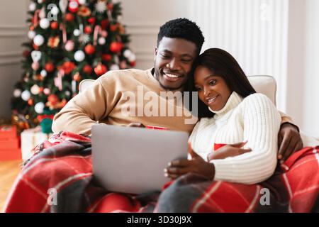 La famiglia Happy Black si diverte con la notte del film di Natale a casa con tè la vigilia di Capodanno Foto Stock