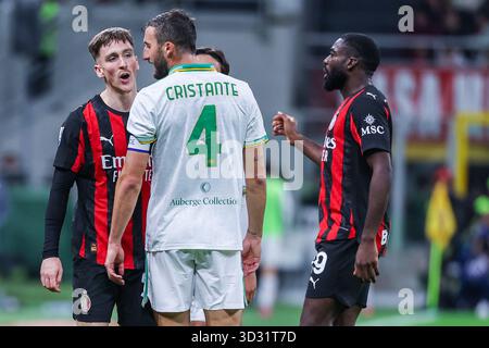 Alexis Saelemaekers dell'AC Milan discute con Bryan Cristante dell'AS Roma durante la partita di calcio di serie A 2025/26 tra l'AC Milan e L'AS Roma allo Stadio San Siro di Milano Foto Stock