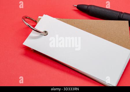 Blocco note bianco a forma di banner con spazio personalizzabile per il testo su sfondo rosso Foto Stock