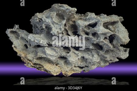 Basalto scoriaceo proveniente dall'Islanda, che mostra un'intricata rete di vescicole formate da gas vulcanici intrappolati durante l'eruzione. Foto Stock