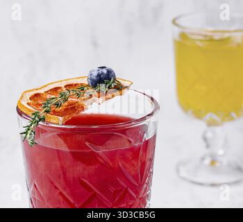 Cibo, cocktail di margarita all'arancia rossa con ghiaccio e timo Foto Stock