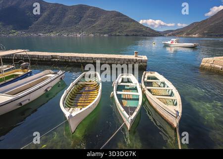 Tre piccole barche da pesca sul mare della bellissima città di Perast nella Baia di Kotor, Montenegro Foto Stock