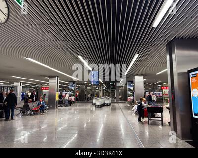 Balice, Polonia - 4 ottobre 2025: Terminal dell'aeroporto polacco di Cracovia con viaggiatori, posti a sedere, mostre e architettura moderna. Foto Stock