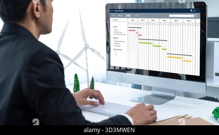 Software di pianificazione dei progetti per la gestione dei progetti aziendali sullo schermo del computer che mostra il grafico della cronologia del progetto del team Foto Stock