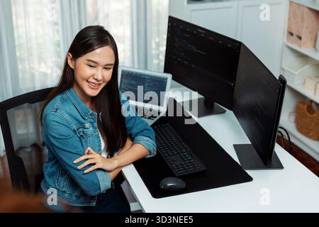 Giovane e bellissimo sviluppatore IT asiatico che desidera presentare con informazioni online su pc con applicazione dati programma di codifica, indossando maglietta jeans Foto Stock