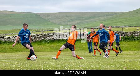 La squadra di calcio amatoriale dei Papay gioca contro Sanday nella Orkney Amateur Football Association League (Orcadian Parish Cup), Pierowall, Westray, Scozia, Regno Unito Foto Stock