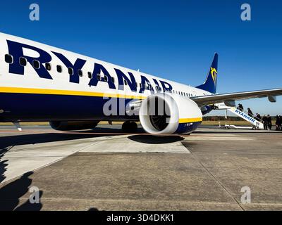 Nowy Dwor Mazowiecki, Polonia - 22 ottobre 2025: Jet Ryanair sull'asfalto all'aeroporto di Modlin con scale d'imbarco e passeggeri. Foto Stock