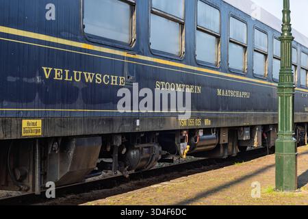 Vista laterale di una carrozza vintage blu scuro dalla ferrovia storica Veluwsche Stoomtrein Maatschappij (VSM), con scritte dorate. Foto Stock