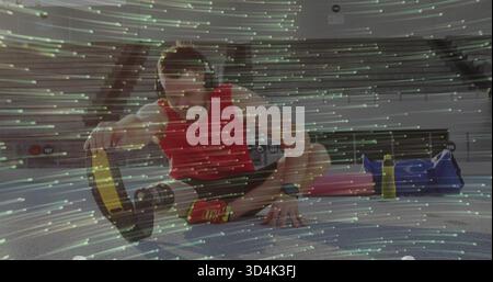 Regola l'atleta indossando la maglia rossa e pantaloncini neri, toccando la lama di sprinting protesica in pista Foto Stock