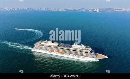 QINGDAO, CINA - 12 NOVEMBRE 2025 - la prima nave da crociera di lusso a cinque stelle della Cina con bandiera rossa, LA ZHAO SHANG YI DUN, la nave da crociera parte dalla baia di Jiaozhou verso il mare aperto a Qingdao, provincia di Shandong, Cina, il 12 novembre 2025. Foto Stock