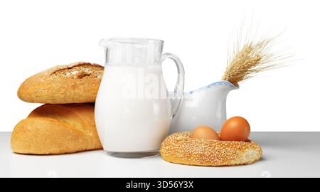 Pane fresco, latte e uova disposti su una superficie pulita per una colazione sana Foto Stock