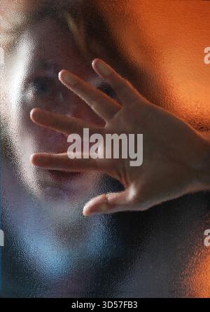 Frau hinter einer Glasscheibe model realase vorhanden GER, 20251030, Frau hinter einer Glasscheibe an einer Eingangstür *** donna dietro un pannello di vetro modello realase available GER, 20251030, donna dietro un pannello di vetro alla porta di ingresso M:RY Foto Stock