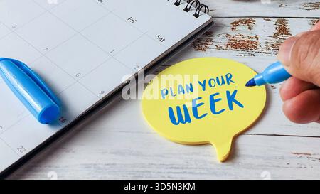 Pianificate il vostro concetto di gestione del tempo settimanale con la scrittura a mano su bolla vocale blocco note e calendario Foto Stock