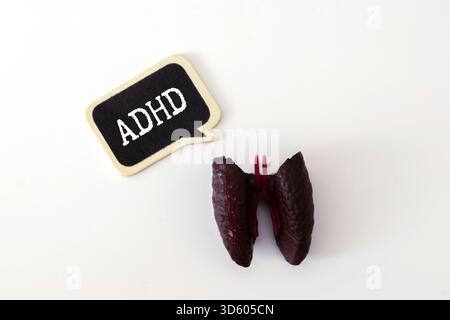 word adhd is made of wooden cubes on a gray background with stethoscope Stock Photo