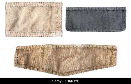 Foto isolata di toppe in tessuto marrone e nero con bordi di cucitura su sfondo bianco. Foto Stock