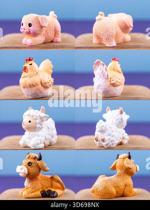 Primo piano di piccole e graziose statuine di animali domestici: Pollo, maialino, mucca, agnello, esposte su un podio di legno Foto Stock