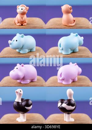 Primo piano di piccole e graziose statuine di animali africani - scimmia, ippopotamo, rinoceronte, struzzo - poste su un podio di legno Foto Stock