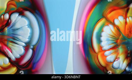 Immagini luminose e fluide che mostrano motivi simmetrici vivaci e colorati Foto Stock
