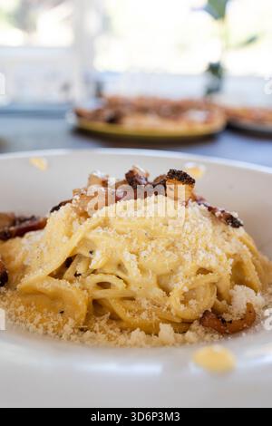 Piatto di classica carbonara romana con guanciale e uova, condito con pecorino romano Foto Stock