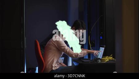 Camicia e giacca scura in collaborazione con AV team che controllano laptop e cavi gialli dietro le quinte Foto Stock