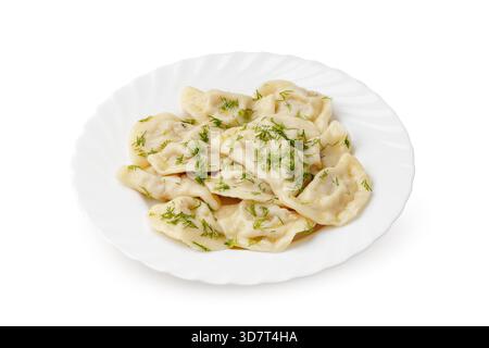 Deliziosi gnocchi serviti con erbe fresche su un piatto bianco Foto Stock