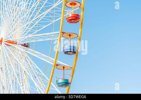 Schema della struttura di supporto in metallo giallo e bianco e dei sedili colorati di un'attrazione del parco divertimenti Foto Stock
