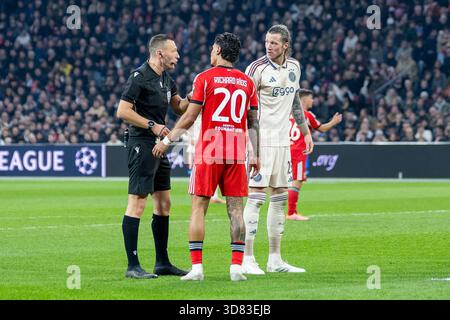25.11.2025, Fussball: UEFA Champions League, Saison 2025/2026, Gruppenphase, 05. Spieltag, Ajax Amsterdam - Benfica Lissabon nella der Johan Cruijff Arena di Amsterdam. Schiedsrichter Sven Jablonski im Gespraech mit Richard Rios (Benfica Lissabon, n. 20) und Wout Weghorst (Ajax Amsterdam, n. 25). Foto: Kirchner-Media/Thomas Haesler Foto Stock