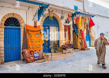 Trafficata via dello shopping con turisti e venditori ambulanti nella storica medina di Essaouira, Marocco Foto Stock
