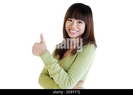 Giovane donna asiatica dando pollice su segno Foto Stock