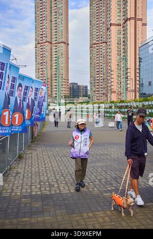 Hong Kong, Cina. 7 dicembre 2025. L'assistente di un candidato distribuisce volantini vicino a una stazione elettorale a Tin Shui Wai. Le elezioni generali del Consiglio legislativo di Hong Kong del 2025 si svolgeranno il 7 dicembre 2025 per eleggere i 90 membri dell'ottavo Consiglio legislativo di Hong Kong. Credito: SOPA Images Limited/Alamy Live News Foto Stock