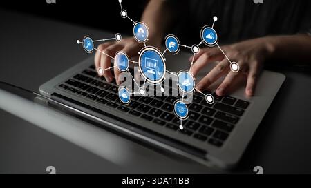 Vista ravvicinata della digitazione manuale sulla tastiera di un notebook, circondata da icone digitali che rappresentano connettività, tecnologia e comunicazione moderna in un Foto Stock