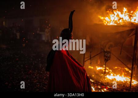 Antigua Guatemala, Guatemala. 8 dicembre 2025. Un uomo vestito da diavolo passa davanti al falò, durante l'incendio del Diavolo alla vigilia della celebrazione della Vergine dell'Immacolata Concezione, festeggiamenti che segnano l'inizio del Natale in Guatemala. (Foto di Luis Soto/SOPA Images/Sipa USA) credito: SIPA USA/Alamy Live News Foto Stock