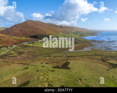 Vista aerea del tranquillo paesaggio dove le aspre montagne incontrano il mare tranquillo lungo la costa, Inch Beach, Contea di Kerry, Irlanda. Foto Stock