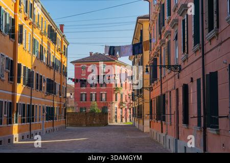 Viuzze colorate, stradina residenziale a Venezia, Italia, facciate colorate, finestre con persiane, lavanderia sospesa. Foto Stock