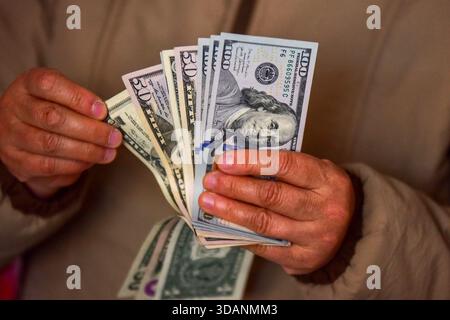 In questa illustrazione fotografica, sono state sventolate varie denominazioni statunitensi (come $ 1, $ 20, $ 50, $ 100), evidenziando una gamma di valori delle banconote. Mercoledì la Federal Reserve americana ha deciso di abbassare l'intervallo target per il tasso di interesse dei fondi federali di 25 punti base, dal 3,5 al 3,75%, segnando il suo terzo taglio di tasso quest'anno. Foto Stock