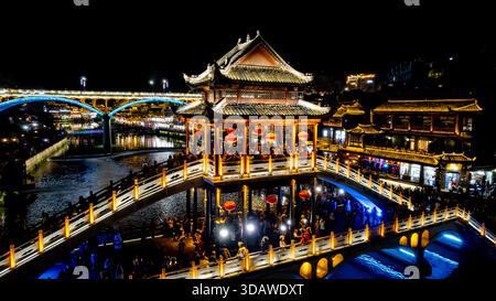 Vista aerea notturna che cattura il Ponte della neve illuminato con il Ponte Nanhua sullo sfondo, mostrando l'atmosfera vivace e notturna Foto Stock