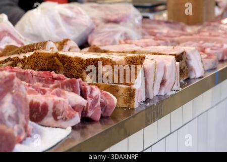 I tagli di carne freschi si allineano in modo attraente in una vivace bancarella del mercato. Kiev, Ucraina. 12 dicembre 2025. Foto Stock