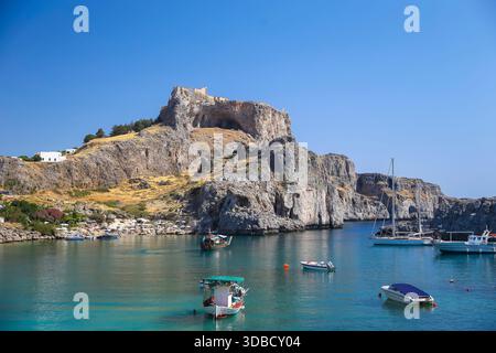 Baia di San Paolo con acque turchesi sotto l'Acropoli di Lindos, Rodi, Grecia. Foto Stock